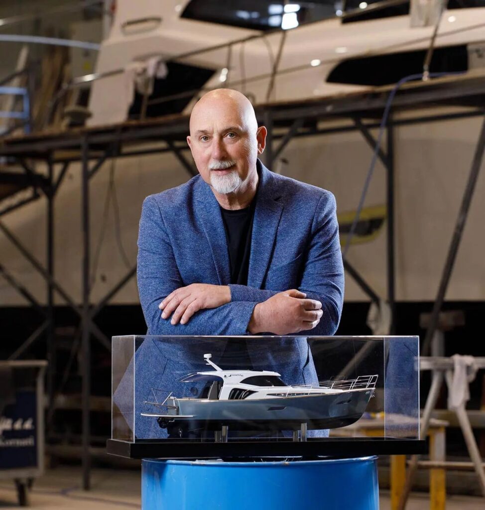 Monachus Yachts founder with yacht model