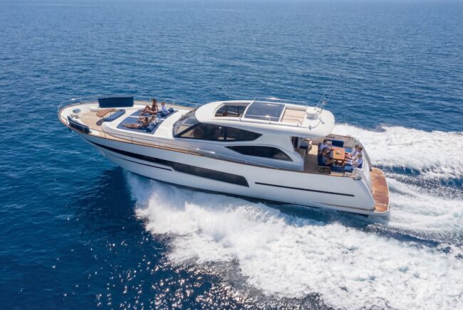 Luxury motor yacht cruising across calm blue sea