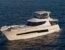 White flybridge yacht on calm open water