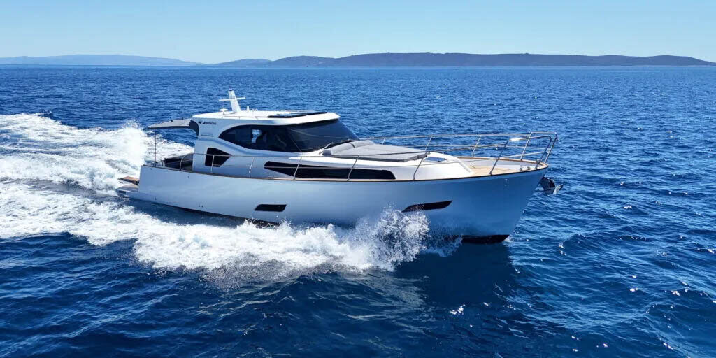 Monachus: Made for Life at Sea White motor yacht cruising across blue water